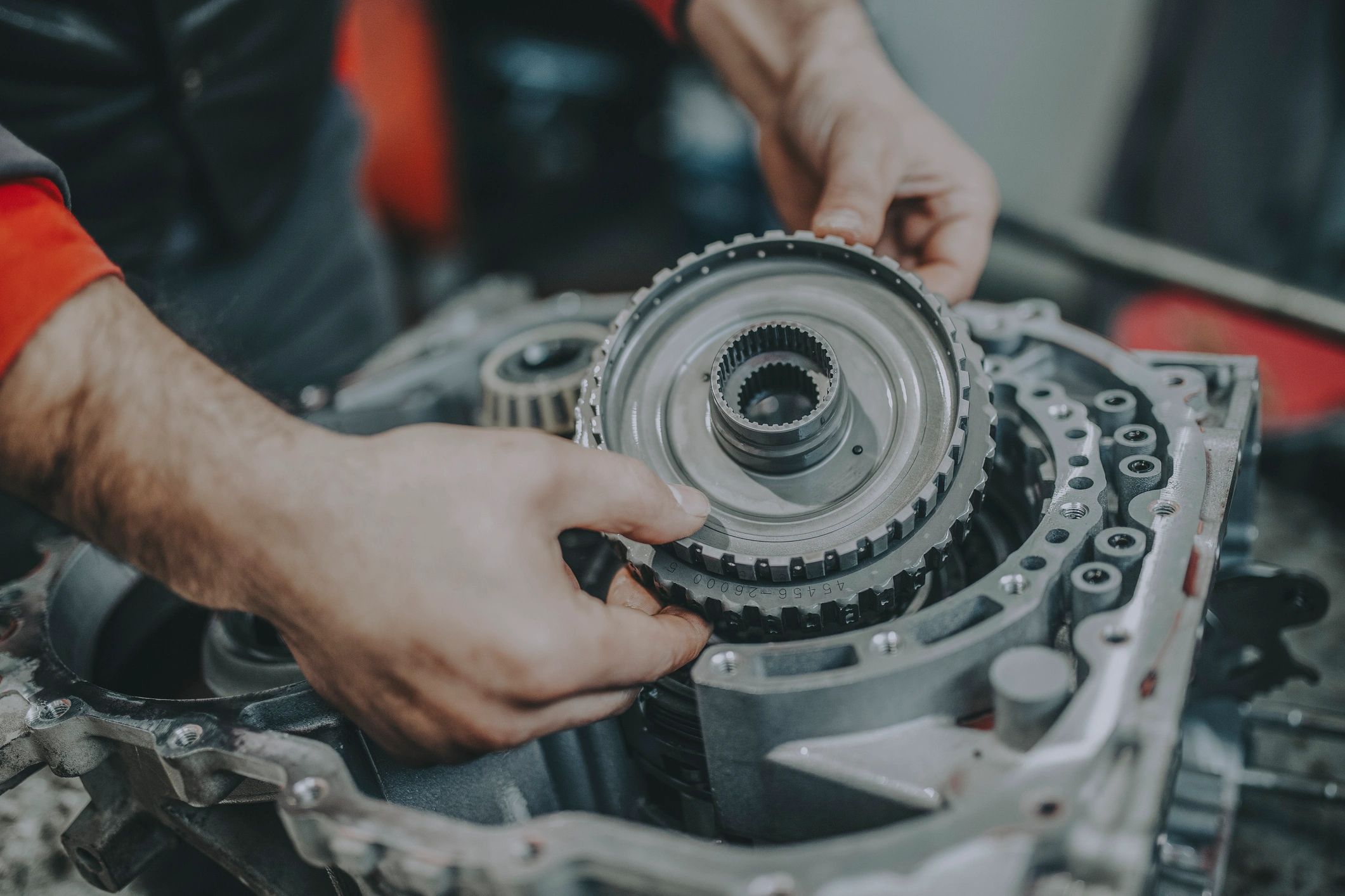 Technician performing a transmission service on a vehicle