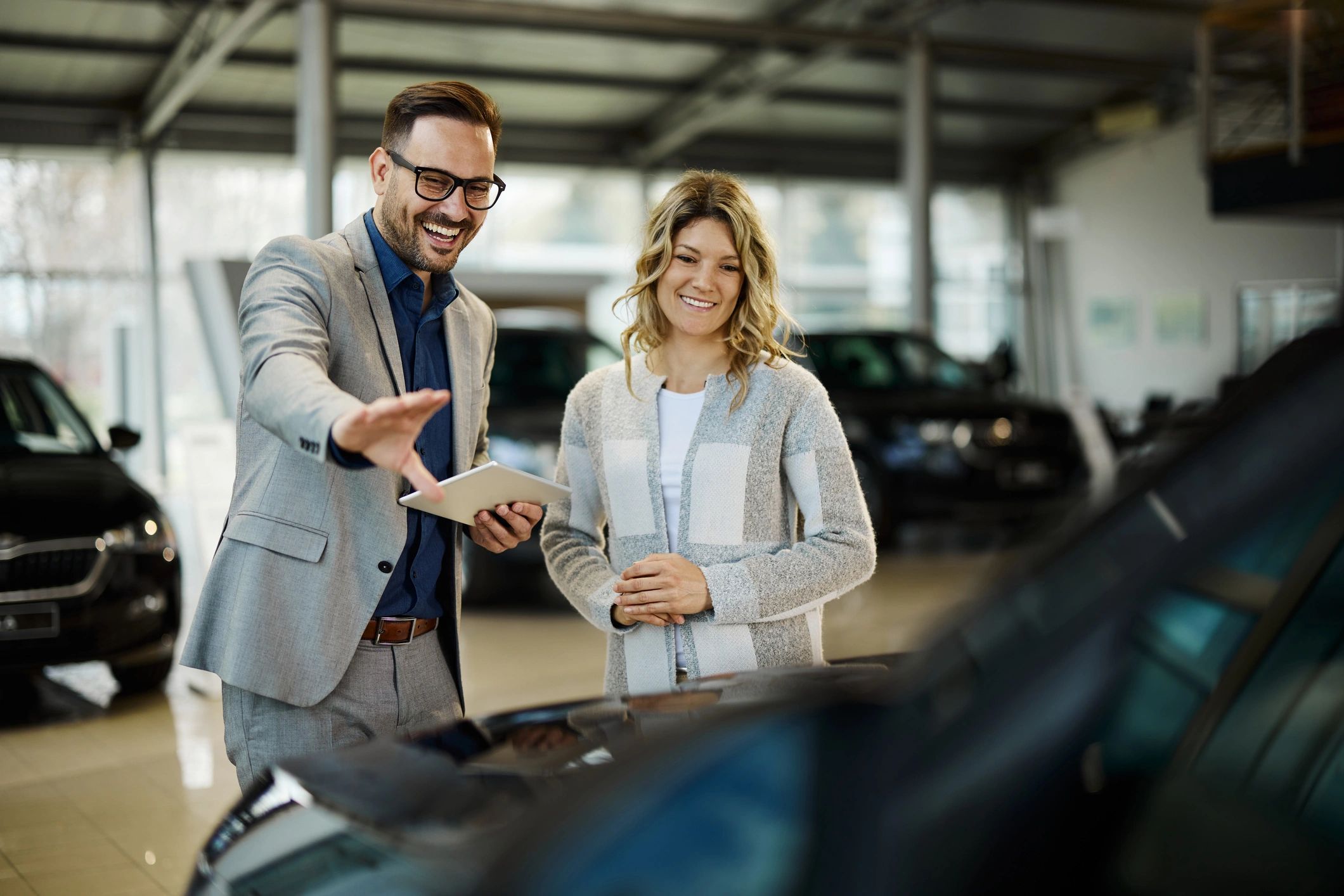 Customer discussing a car purchase in a showroom