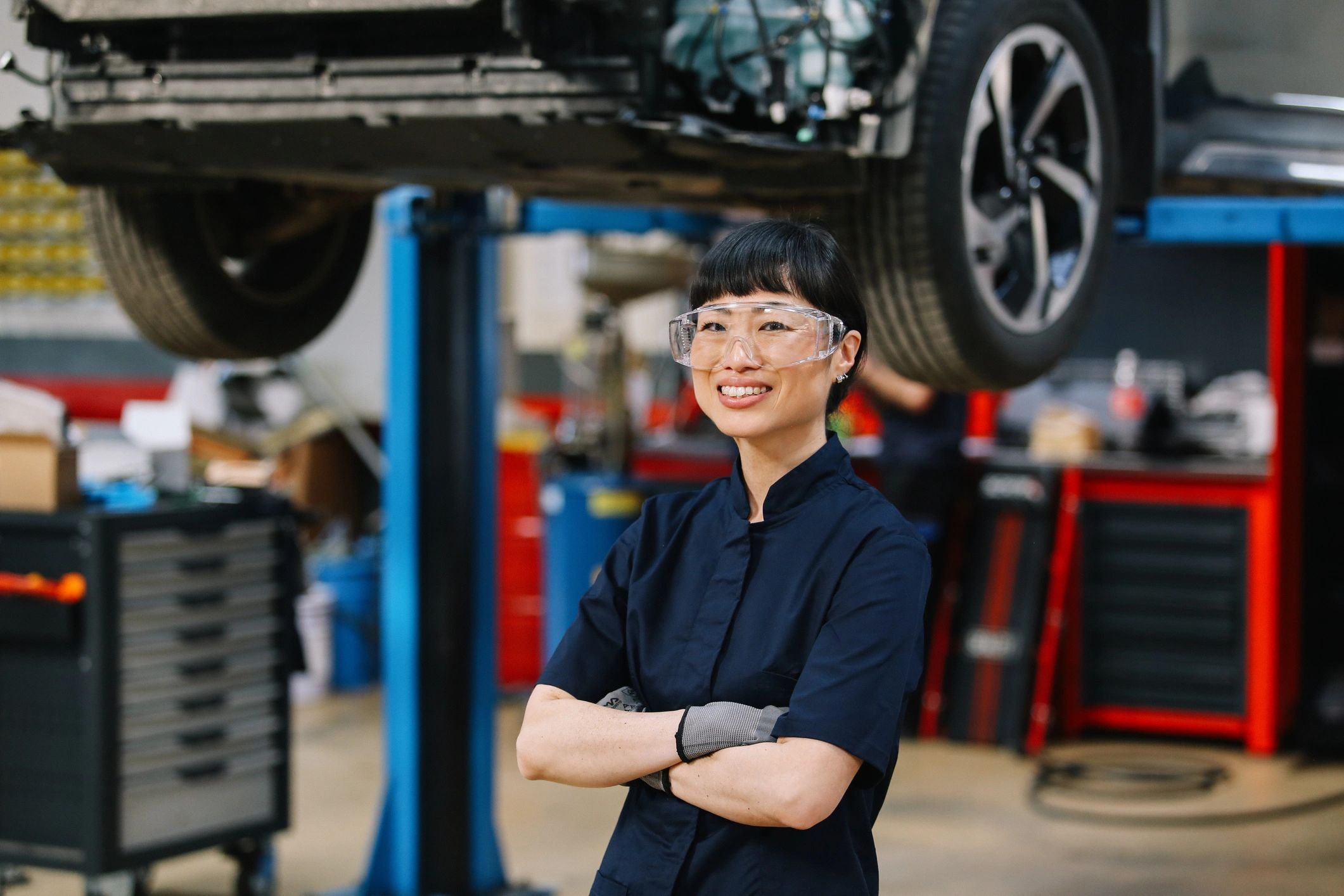 Mechanic performing inspection on a vehicle in a clean auto repair shop
