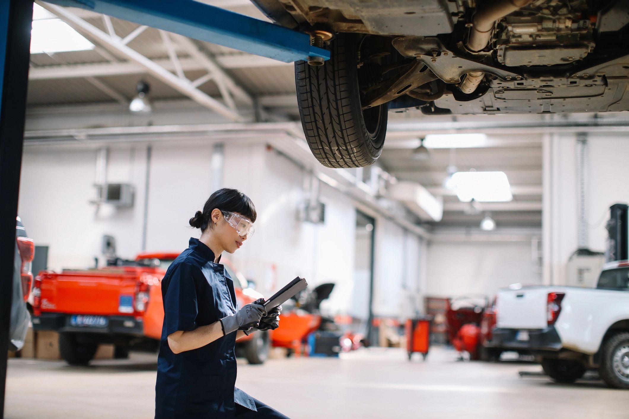 Technician performing a vehicle inspection in a repair shop