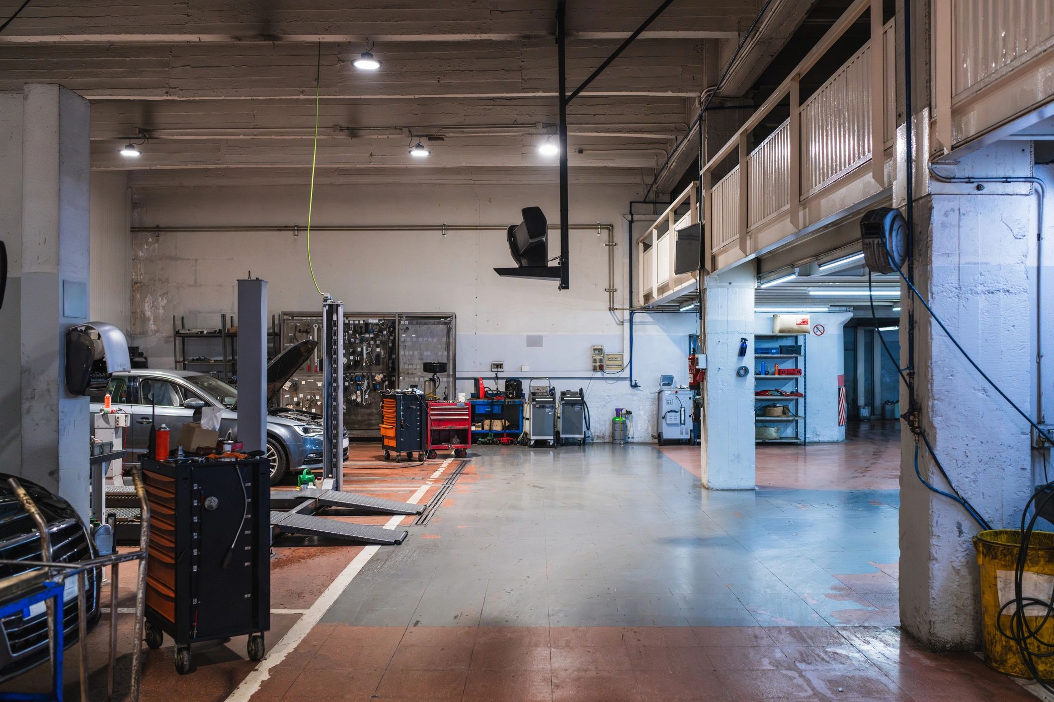 Auto repair shop bay with lifts and toolboxes