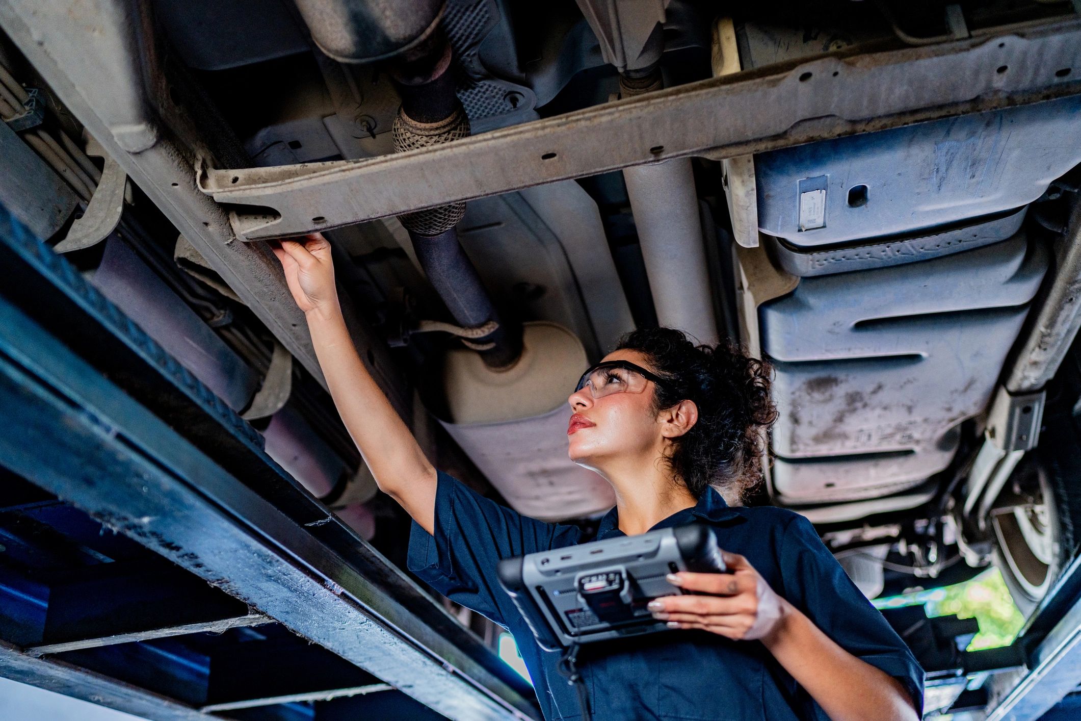 Mechanic inspecting a vehicle in a clean auto repair shop