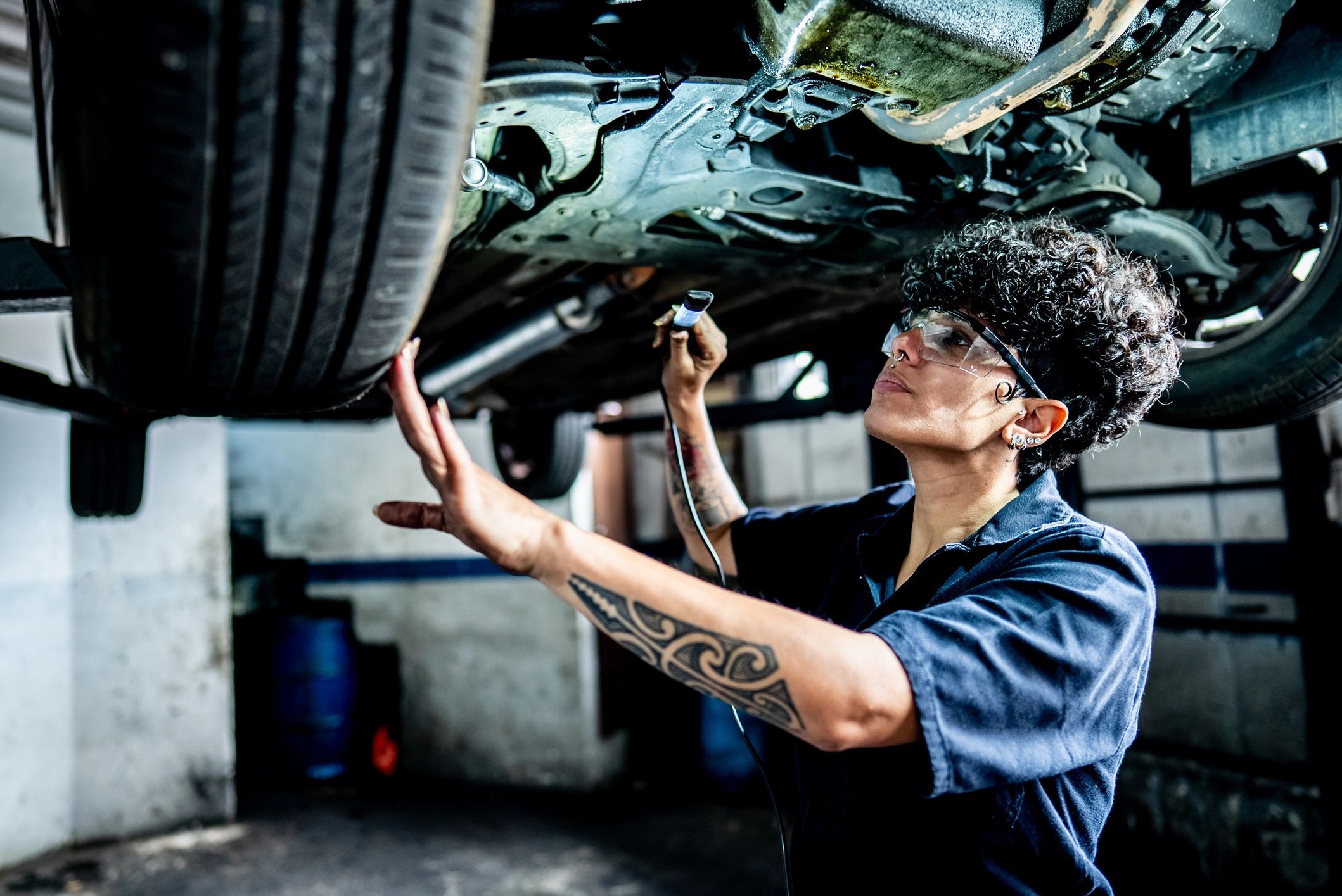 Technician working on a vehicle in a repair shop