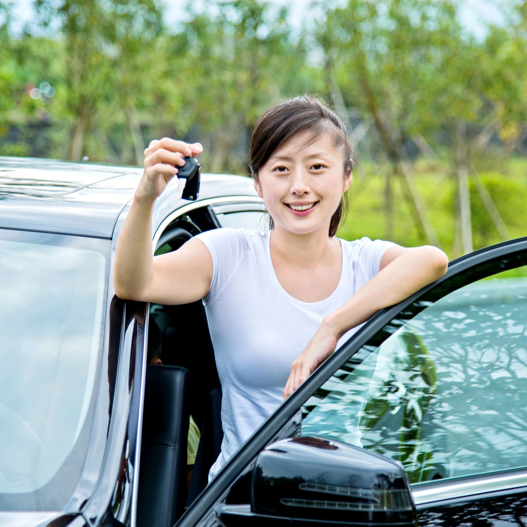 Customer holding car keys after service